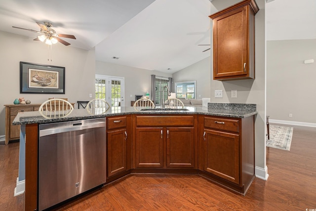 2010 Chattooga Ct, Myrtle Beach, SC 29588 - kitchen with stainless steel dishwasher, ceiling fan, vaulted ceiling, dark wood-type flooring, and dark stone countertops