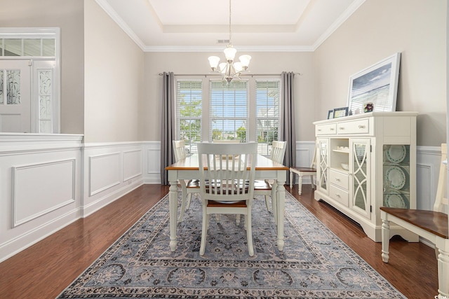 2010 Chattooga Ct, Myrtle Beach, SC 29588 - dining area featuring a chandelier, a tray ceiling, dark wood-style flooring, a decorative wall, and a wainscoted wall