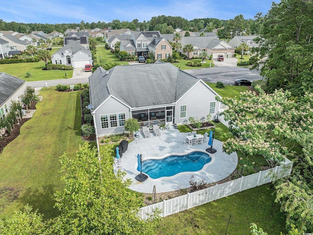 2010 Chattooga Ct, Myrtle Beach, SC 29588 - back of house featuring a residential view, a fenced backyard, a patio area, and a sunroom