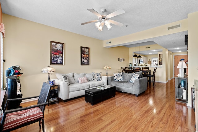 1401 Lighthouse Dr Unit 4334, North Myrtle Beach, SC 29582 - living area with light wood-style flooring, ceiling fan, and a textured ceiling