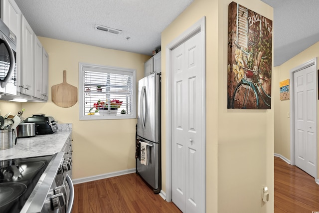 1401 Lighthouse Dr Unit 4334, North Myrtle Beach, SC 29582 - kitchen featuring appliances with stainless steel finishes, dark wood-style floors, light countertops, and a textured ceiling