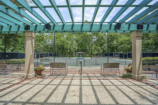 1401 Lighthouse Dr Unit 4334, North Myrtle Beach, SC 29582 - view of community with a tennis court, a pergola, and view of wooded area