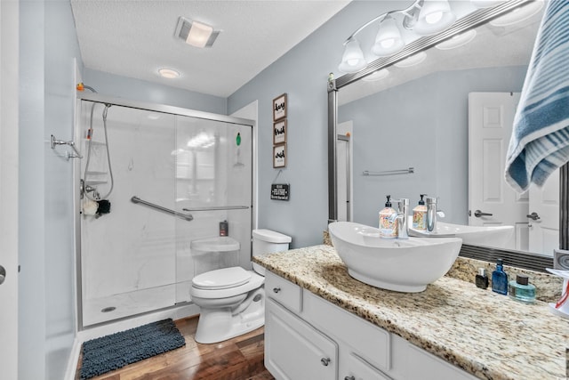 1401 Lighthouse Dr Unit 4334, North Myrtle Beach, SC 29582 - bathroom featuring a shower stall, vanity, wood finished floors, and a textured ceiling
