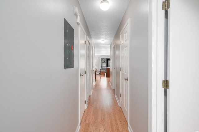 3700 Golf Colony Ln Unit 26A, Little River, SC 29566 - hall with a textured ceiling, light wood finished floors, and electric panel