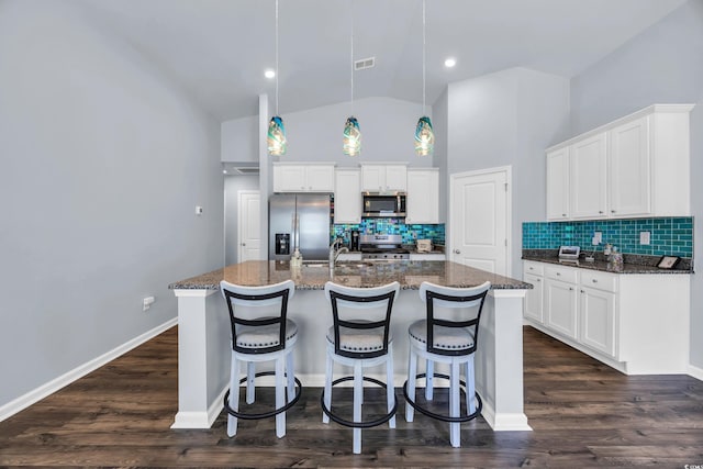1520 Jardine Loop, Little River, SC 29566 - kitchen with stainless steel appliances, backsplash, a breakfast bar, white cabinetry, and high vaulted ceiling