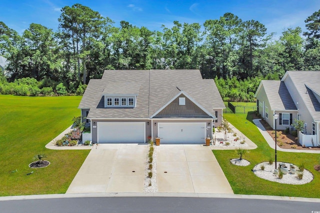 1520 Jardine Loop, Little River, SC 29566 - view of front of home with driveway, a front yard, a garage, and view of wooded area