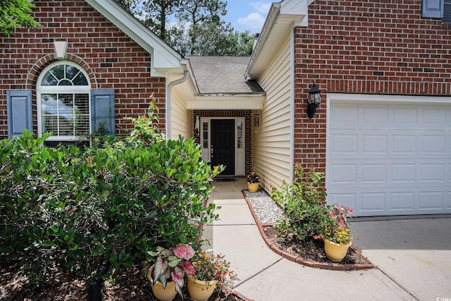 364 Vesta Dr, Myrtle Beach, SC 29579 - view of exterior entry with brick siding, an attached garage, and a shingled roof