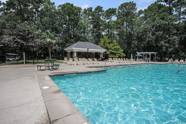 364 Vesta Dr, Myrtle Beach, SC 29579 - community pool with a pergola, a patio, and view of wooded area