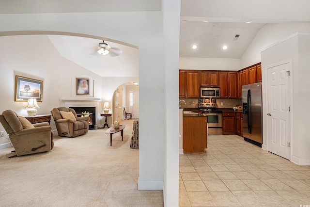 364 Vesta Dr, Myrtle Beach, SC 29579 - kitchen with stainless steel appliances, lofted ceiling, arched walkways, open floor plan, and dark countertops