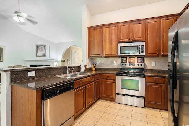 364 Vesta Dr, Myrtle Beach, SC 29579 - kitchen with appliances with stainless steel finishes, a peninsula, tasteful backsplash, light tile patterned flooring, and arched walkways