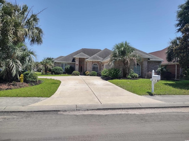 413 Sea Vista Ln, North Myrtle Beach, SC 29582 - single story home with driveway, a front lawn, brick siding, and an attached garage
