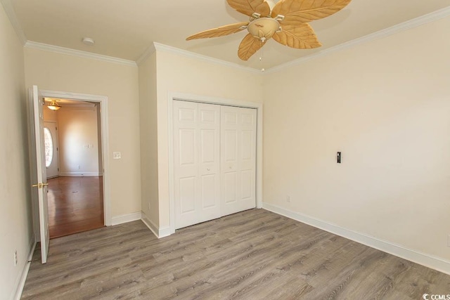 413 Sea Vista Ln, North Myrtle Beach, SC 29582 - unfurnished bedroom with crown molding, light wood-style flooring, and a closet