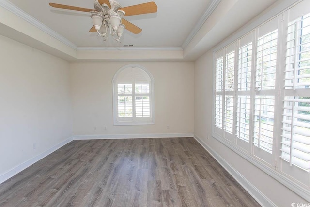 413 Sea Vista Ln, North Myrtle Beach, SC 29582 - unfurnished room with a raised ceiling, ornamental molding, wood finished floors, and a ceiling fan