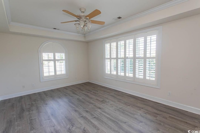 413 Sea Vista Ln, North Myrtle Beach, SC 29582 - unfurnished room featuring crown molding, healthy amount of natural light, a tray ceiling, and wood finished floors