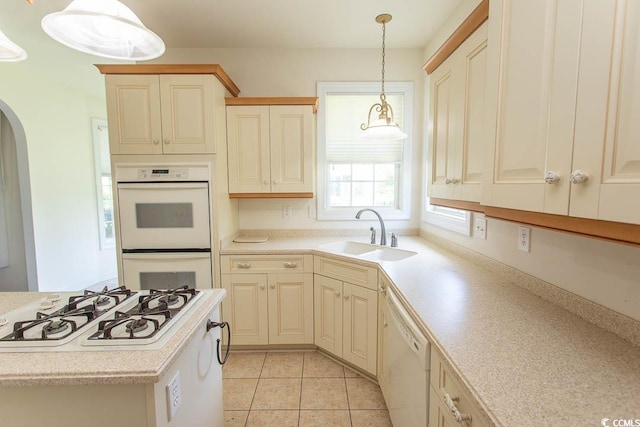 413 Sea Vista Ln, North Myrtle Beach, SC 29582 - kitchen featuring white appliances, arched walkways, light countertops, hanging light fixtures, and light tile patterned floors