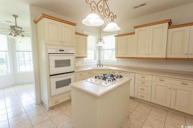 413 Sea Vista Ln, North Myrtle Beach, SC 29582 - kitchen with white appliances, a ceiling fan, light tile patterned flooring, and light countertops