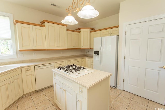 413 Sea Vista Ln, North Myrtle Beach, SC 29582 - kitchen with white appliances, light tile patterned floors, a center island, and pendant lighting