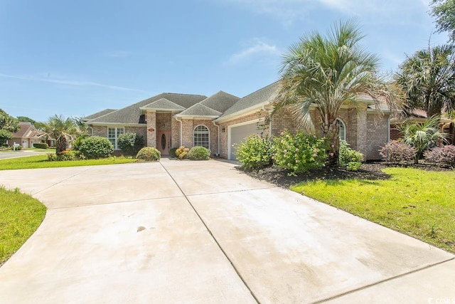 413 Sea Vista Ln, North Myrtle Beach, SC 29582 - view of front of home featuring driveway, a garage, brick siding, and a front lawn