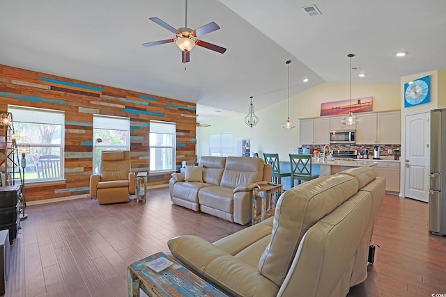 232 Angel Wing Dr, Myrtle Beach, SC 29588 - living room featuring a ceiling fan, wood walls, healthy amount of natural light, dark wood-style floors, and high vaulted ceiling