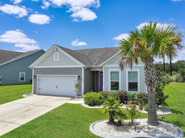232 Angel Wing Dr, Myrtle Beach, SC 29588 - view of front of home featuring board and batten siding, an attached garage, concrete driveway, a front lawn, and roof with shingles