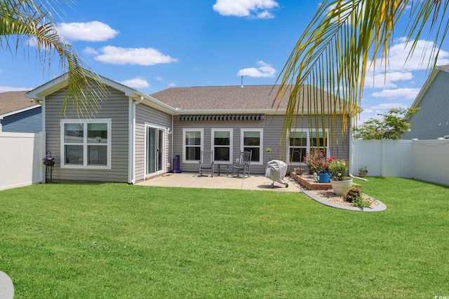 232 Angel Wing Dr, Myrtle Beach, SC 29588 - back of property with a fenced backyard, a patio, and a shingled roof