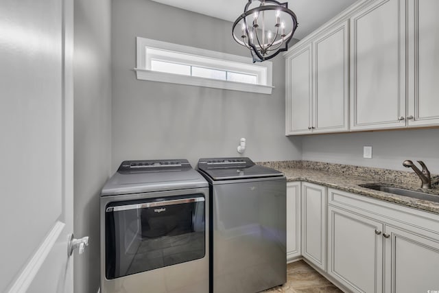 124 Turtle Creek Dr, Pawleys Island, SC 29585 - washroom featuring a chandelier, washer and dryer, and cabinet space