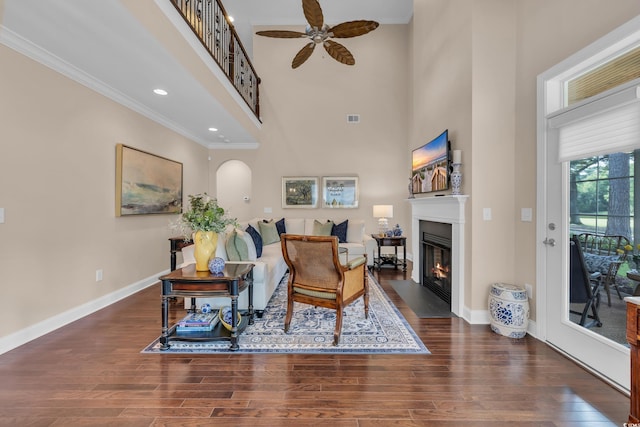 124 Turtle Creek Dr, Pawleys Island, SC 29585 - living area featuring a towering ceiling, ornamental molding, wood finished floors, a fireplace with flush hearth, and a ceiling fan