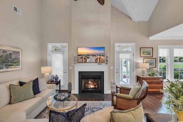 124 Turtle Creek Dr, Pawleys Island, SC 29585 - living room with high vaulted ceiling, wood finished floors, and a warm lit fireplace