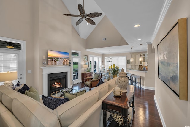 124 Turtle Creek Dr, Pawleys Island, SC 29585 - living room with a ceiling fan, dark wood-style flooring, a lit fireplace, vaulted ceiling, and ornamental molding