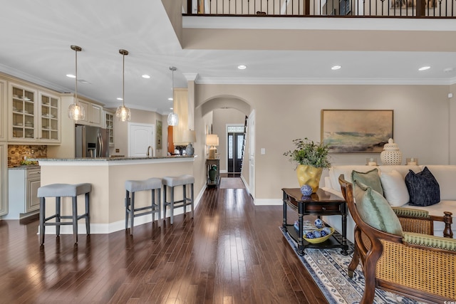 124 Turtle Creek Dr, Pawleys Island, SC 29585 - living area with arched walkways, recessed lighting, dark wood-style floors, and ornamental molding
