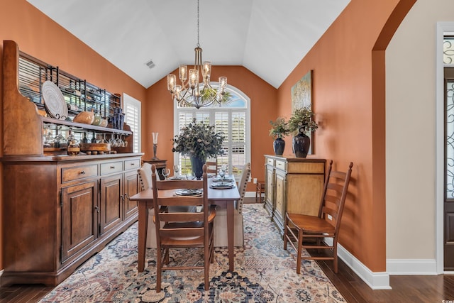 124 Turtle Creek Dr, Pawleys Island, SC 29585 - dining space featuring a chandelier, arched walkways, lofted ceiling, and dark wood finished floors
