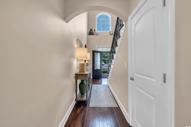 124 Turtle Creek Dr, Pawleys Island, SC 29585 - foyer entrance with arched walkways, dark wood finished floors, stairway, and a towering ceiling