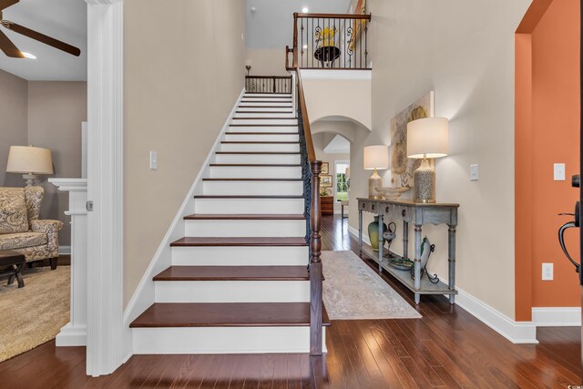 124 Turtle Creek Dr, Pawleys Island, SC 29585 - stairs featuring arched walkways, ceiling fan, hardwood / wood-style floors, and a high ceiling