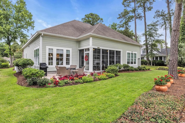 124 Turtle Creek Dr, Pawleys Island, SC 29585 - back of house with a patio, a lawn, and roof with shingles