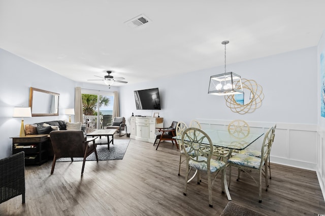 1217 S Ocean Blvd Unit 5, Surfside Beach, SC 29575 - dining room with wood finished floors, ceiling fan, and a wainscoted wall