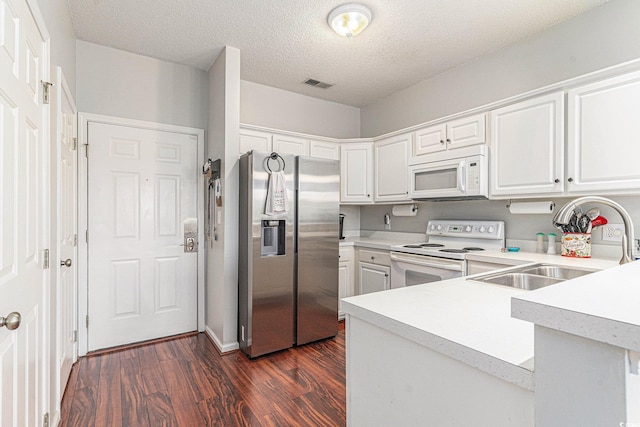 2000 Cross Gate Blvd Unit 202, Surfside Beach, SC 29575 - kitchen with white appliances, light countertops, dark wood-style floors, a peninsula, and white cabinets