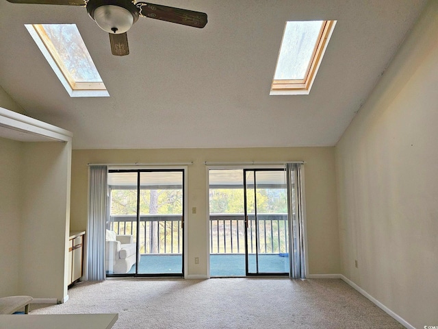 500 Fairway Village Dr Unit 9-K, Myrtle Beach, SC 29588 - unfurnished living room with a skylight, light carpet, a ceiling fan, and lofted ceiling