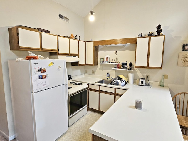 500 Fairway Village Dr Unit 9-K, Myrtle Beach, SC 29588 - kitchen featuring white appliances, under cabinet range hood, light countertops, light floors, and high vaulted ceiling