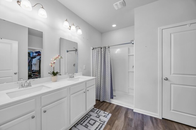 2882 Ophelia Way, Myrtle Beach, SC 29577 - bathroom with a shower with shower curtain, double vanity, wood finished floors, a walk in closet, and recessed lighting