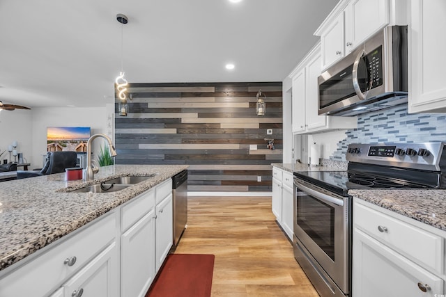 2882 Ophelia Way, Myrtle Beach, SC 29577 - kitchen featuring stainless steel appliances, white cabinetry, backsplash, pendant lighting, and light wood-type flooring