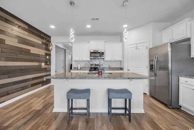 2882 Ophelia Way, Myrtle Beach, SC 29577 - kitchen featuring appliances with stainless steel finishes, a breakfast bar, white cabinets, dark stone counters, and recessed lighting