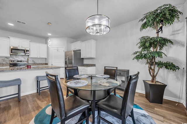 2882 Ophelia Way, Myrtle Beach, SC 29577 - dining area featuring a chandelier, dark wood-type flooring, and recessed lighting