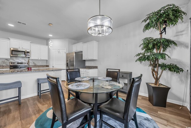 2882 Ophelia Way, Myrtle Beach, SC 29577 - dining space featuring a chandelier, dark wood-style flooring, and recessed lighting