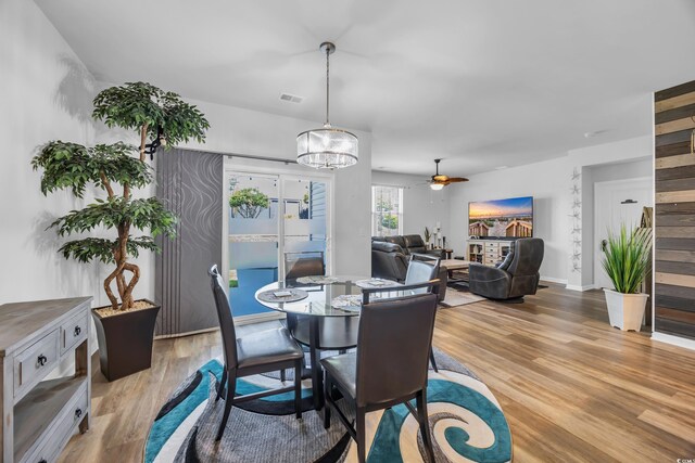 2882 Ophelia Way, Myrtle Beach, SC 29577 - dining space with light wood-style flooring, a chandelier, and ceiling fan
