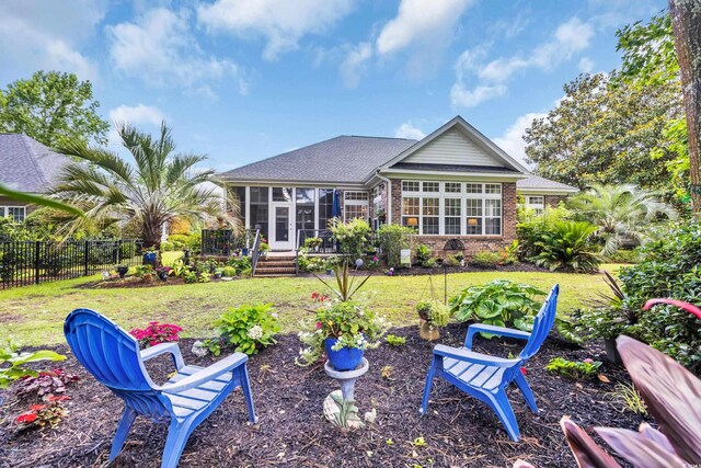 139 Olde Canal Loop, Pawleys Island, SC 29585 - back of property featuring a sunroom, brick siding, and roof with shingles
