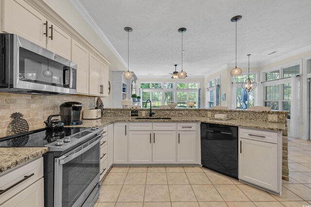 139 Olde Canal Loop, Pawleys Island, SC 29585 - kitchen with stainless steel appliances, ornamental molding, healthy amount of natural light, decorative backsplash, and a peninsula
