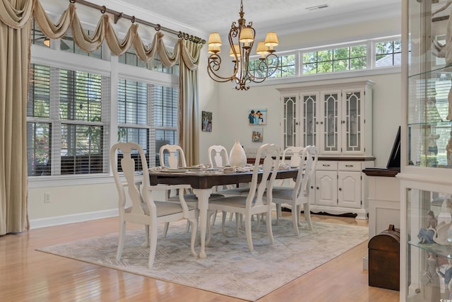 139 Olde Canal Loop, Pawleys Island, SC 29585 - dining room with a chandelier, crown molding, and light wood-style floors