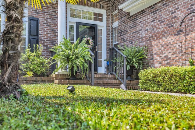 139 Olde Canal Loop, Pawleys Island, SC 29585 - view of exterior entry featuring brick siding