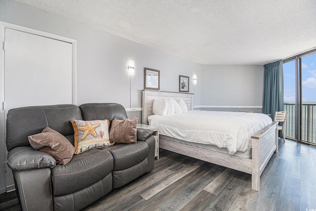9550 Shore Dr Unit 1430, Myrtle Beach, SC 29572 - bedroom featuring a textured ceiling, wood finished floors, a wall of windows, and access to outside
