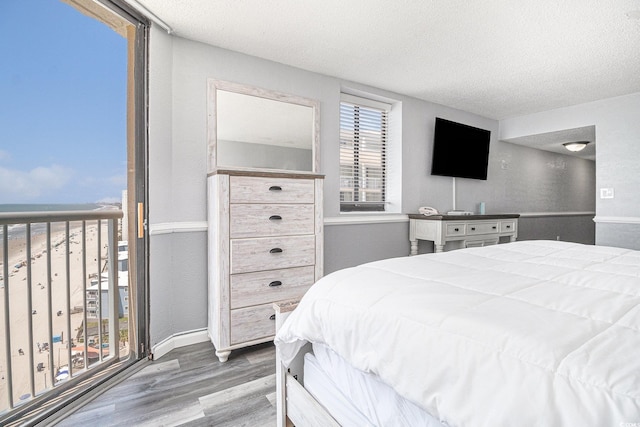 9550 Shore Dr Unit 1430, Myrtle Beach, SC 29572 - bedroom with wood finished floors and a textured ceiling
